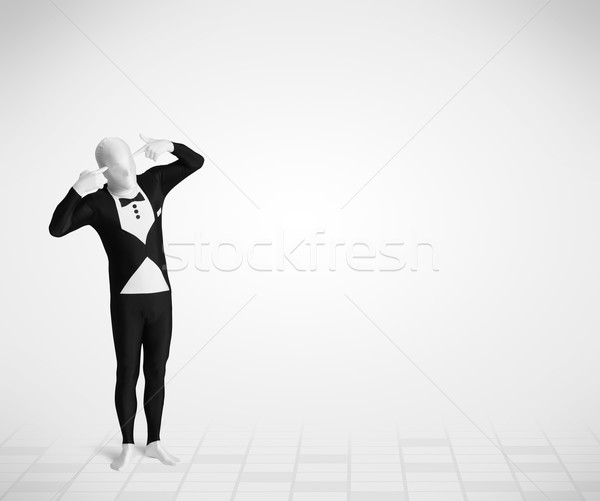 Funny guy in morphsuit body suit looking at copy space Stock photo © ra2studio