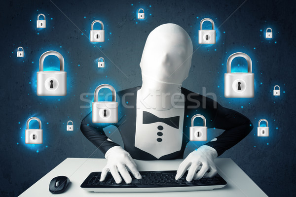 Hacker in disguise with virtual lock symbols and icons Stock photo © ra2studio