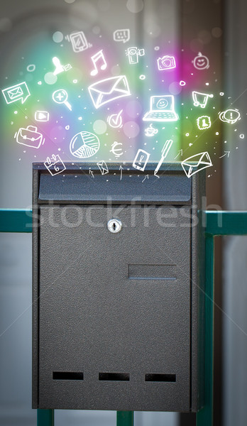 Colorful icons and symbols bursting out of a mailbox Stock photo © ra2studio