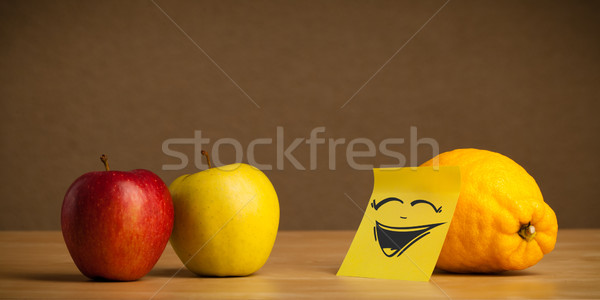 Lemon with post-it note laughing on apples Stock photo © ra2studio