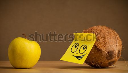 Coconut with post-it note sticking out tongue to apple Stock photo © ra2studio
