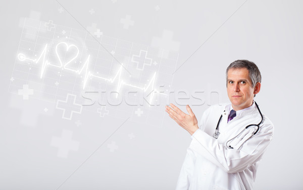 Doctor examinates heartbeat with abstract heart Stock photo © ra2studio