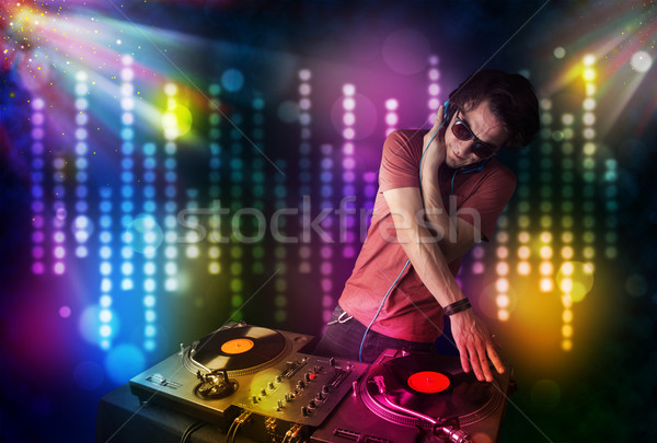 Dj playing songs in a disco with light show Stock photo © ra2studio