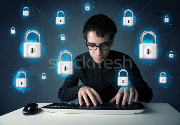 Young hacker with virtual lock symbols and icons Stock photo © ra2studio