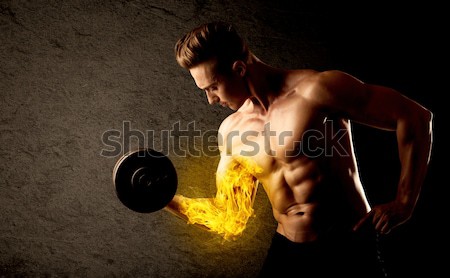 Muscular body builder lifting weight with energy lights on bicep Stock photo © ra2studio