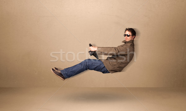Happy funny man driving a flying car concept Stock photo © ra2studio