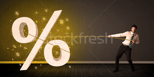 Business man pulling rope with big procent symbol sign  Stock photo © ra2studio