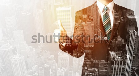 Business person with warm color overlay of city background Stock photo © ra2studio