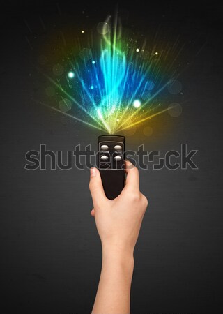 Stock photo: Hand with remote control and explosive signal