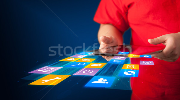Stock photo: Hand holding tablet device with media application