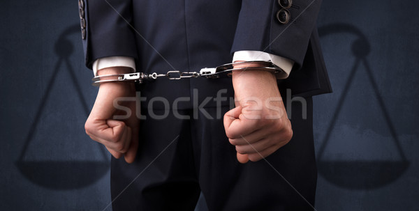Aresztowany człowiek równowagi biznesmen kajdanki ręce Zdjęcia stock © ra2studio