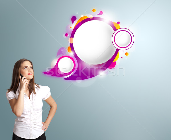 Pretty young woman presenting abstract speech bubble copy space and making phone call Stock photo © ra2studio
