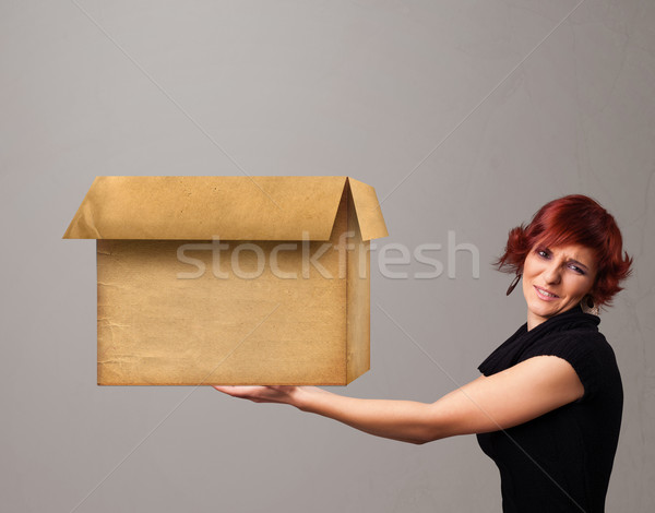 Young woman holding an empty cardboard box Stock photo © ra2studio