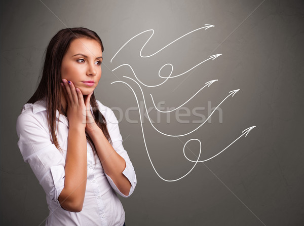 Attractive teenager looking at multiple curly arrows Stock photo © ra2studio