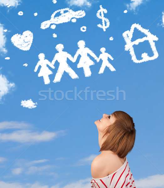 Stock photo: Young girl daydreaming with family and household clouds 