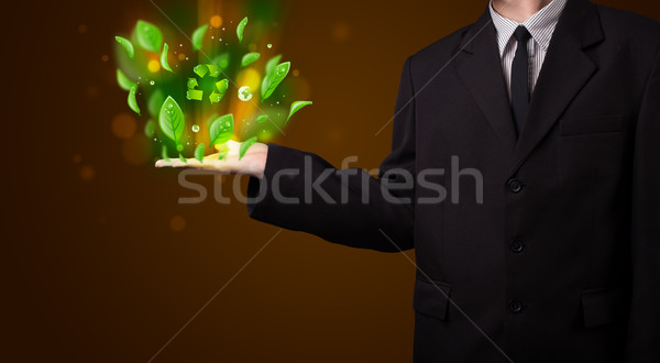 Stock photo: Young businessman presenting eco green leaf recycle energy conce