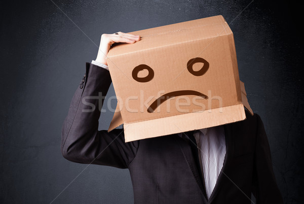 Stock photo: Businessman gesturing with cardboard box on his head with sad fa