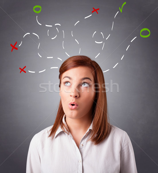 Young woman thinking with abstract marks overhead Stock photo © ra2studio