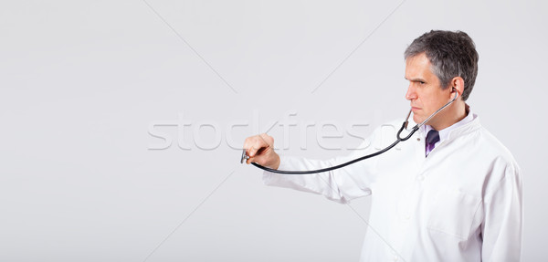 Doctor listening to empty copy space with stethoscope Stock photo © ra2studio