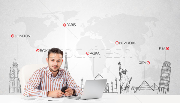 Businessman with world map and major landmarks of the world Stock photo © ra2studio