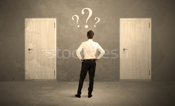 Businessman standing in front of doors Stock photo © ra2studio