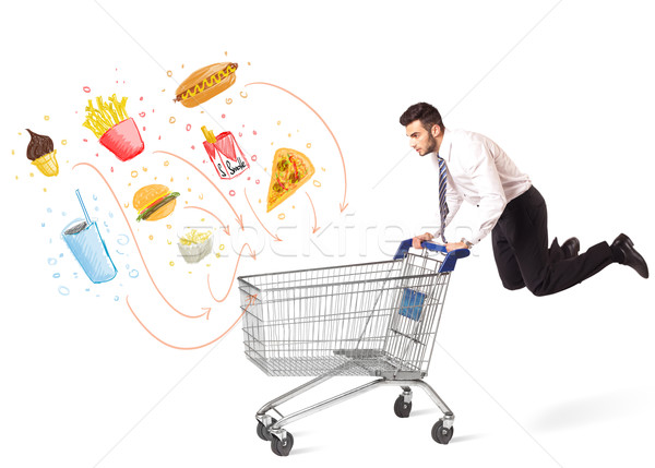 Stock photo: Man with shopping cart with toxic junk food