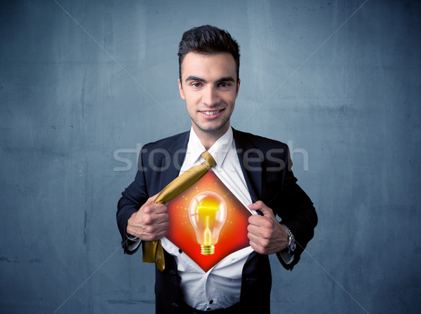 Businessman ripping off shirt and idea light bulb appears  Stock photo © ra2studio