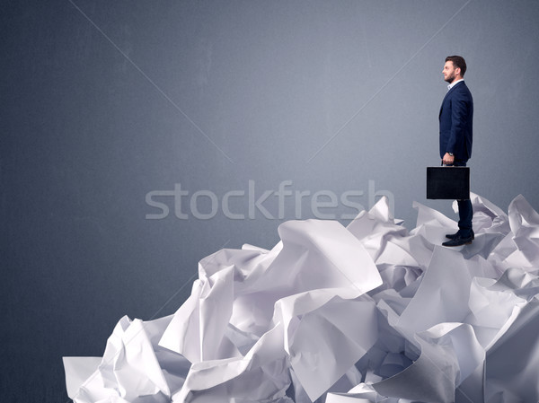 Businessman standing on crumpled paper Stock photo © ra2studio