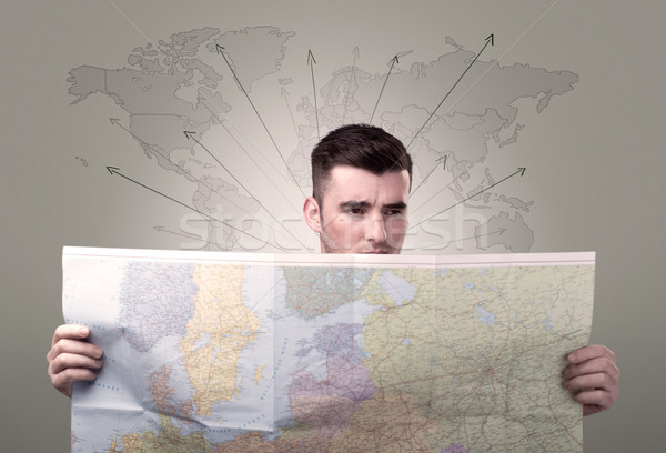 Junger Mann halten Karte gut aussehend Weltkarte Pfeile Stock foto © ra2studio