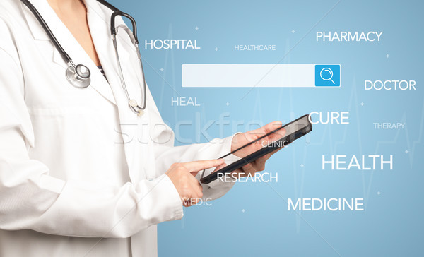 Female doctor with tablet Stock photo © ra2studio