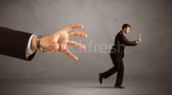 Businessman running from hand Stock photo © ra2studio