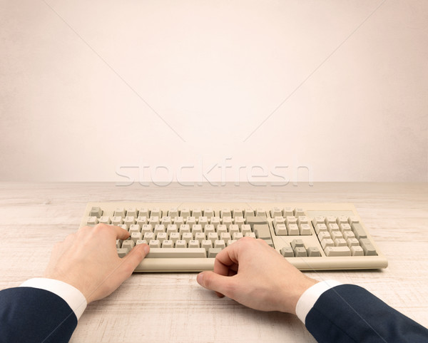 Stock photo: Elegant businessman hand typing on light background