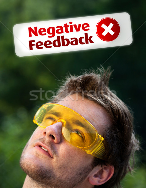 Young head looking at positive negative signs Stock photo © ra2studio