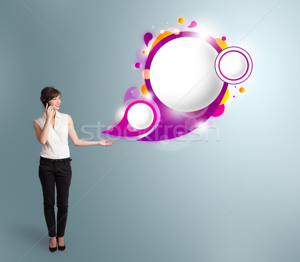 Pretty young woman presenting abstract speech bubble copy space and making phone call Stock photo © ra2studio