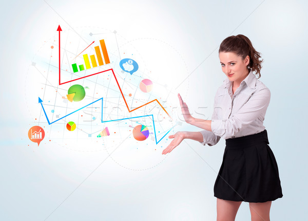 Stock photo: Young business woman presenting colorful charts and diagrams