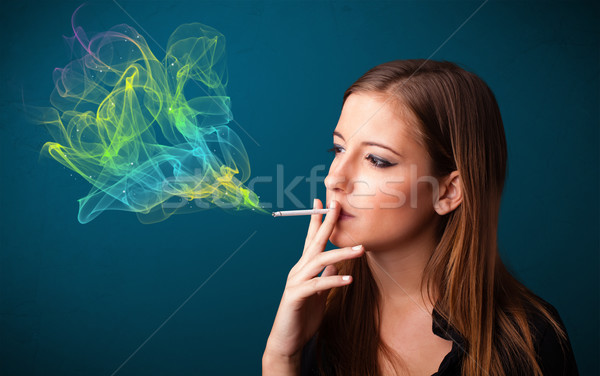 Bastante dama fumar cigarrillo colorido humo Foto stock © ra2studio