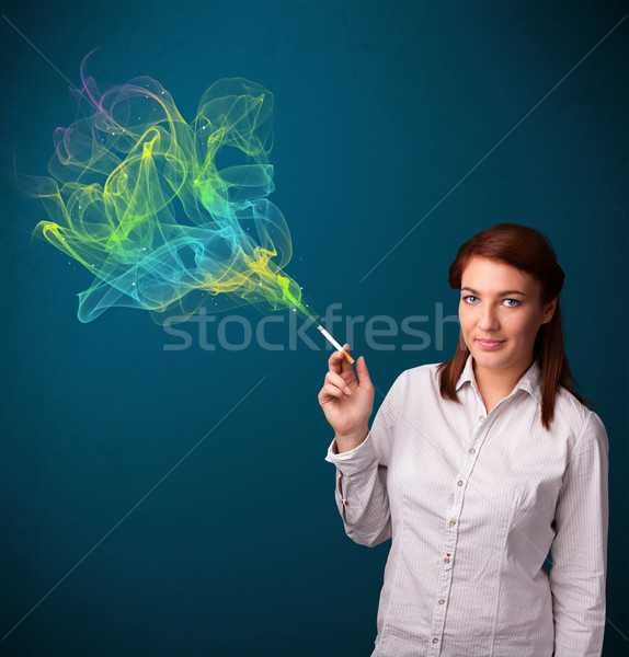 Stock photo: Pretty lady smoking cigarette with colorful smoke