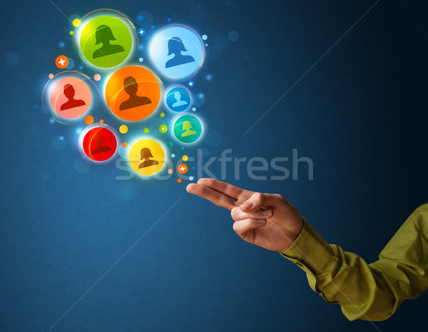 Stock photo: Social media icons coming out of gun shaped hand