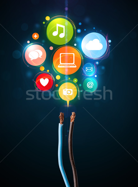 Social media icons coming out of electric cable Stock photo © ra2studio