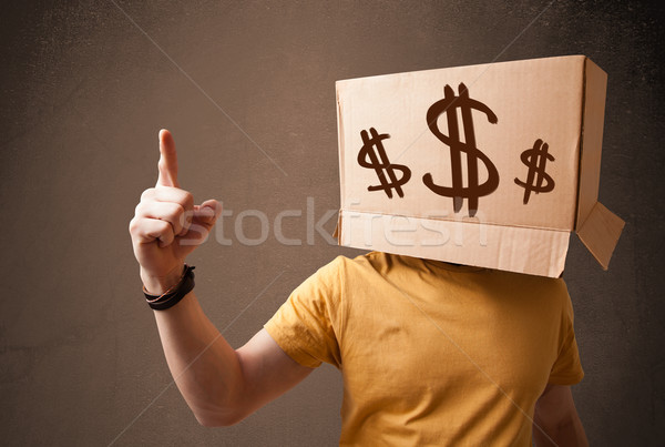Young man gesturing with a cardboard box on his head with dollar Stock photo © ra2studio