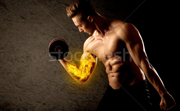 Musculaire bodybuilder poids flaming biceps [[stock_photo]] © ra2studio