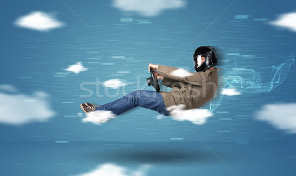 Funny joven conducción nubes azul coche Foto stock © ra2studio