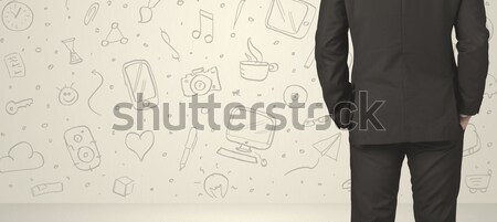 Businessman with social media icons Stock photo © ra2studio