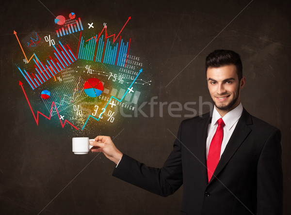 Businessman holding a white cup with diagrams and graphs Stock photo © ra2studio