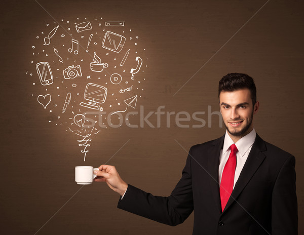 Businessman holding a white cup with social media icons Stock photo © ra2studio