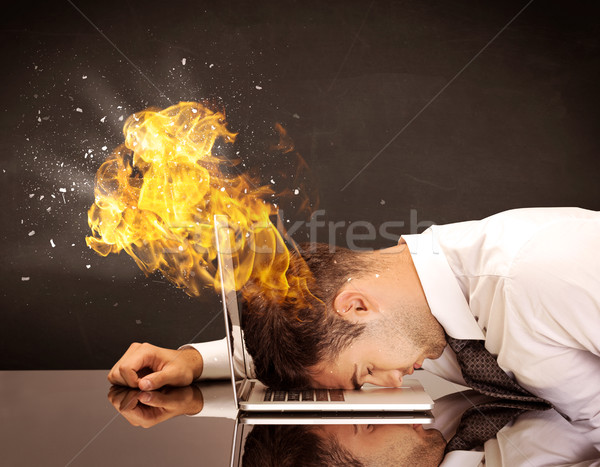 Stressed business man's head is burning Stock photo © ra2studio