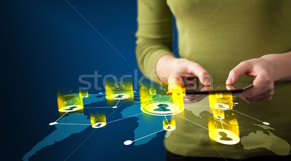 Hand holding tablet device with social network map Stock photo © ra2studio