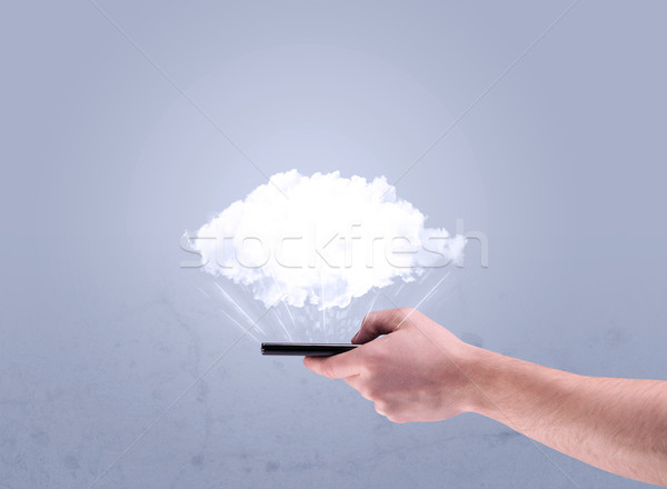 Hand holding phone with empty cloud Stock photo © ra2studio