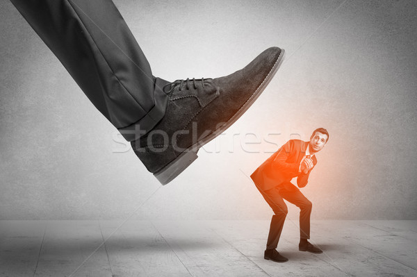 Large foot stepping down small man Stock photo © ra2studio
