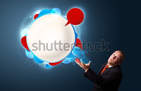Stock photo: funny businessman in suit presenting abstract modern speech bubble copy space